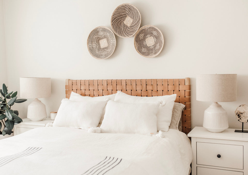 Woven Leather Strap Headboard in beige styled in bedroom with three baskets above headboard. Handcrafted in Bali with teak and leather. - Saffron and Poe
