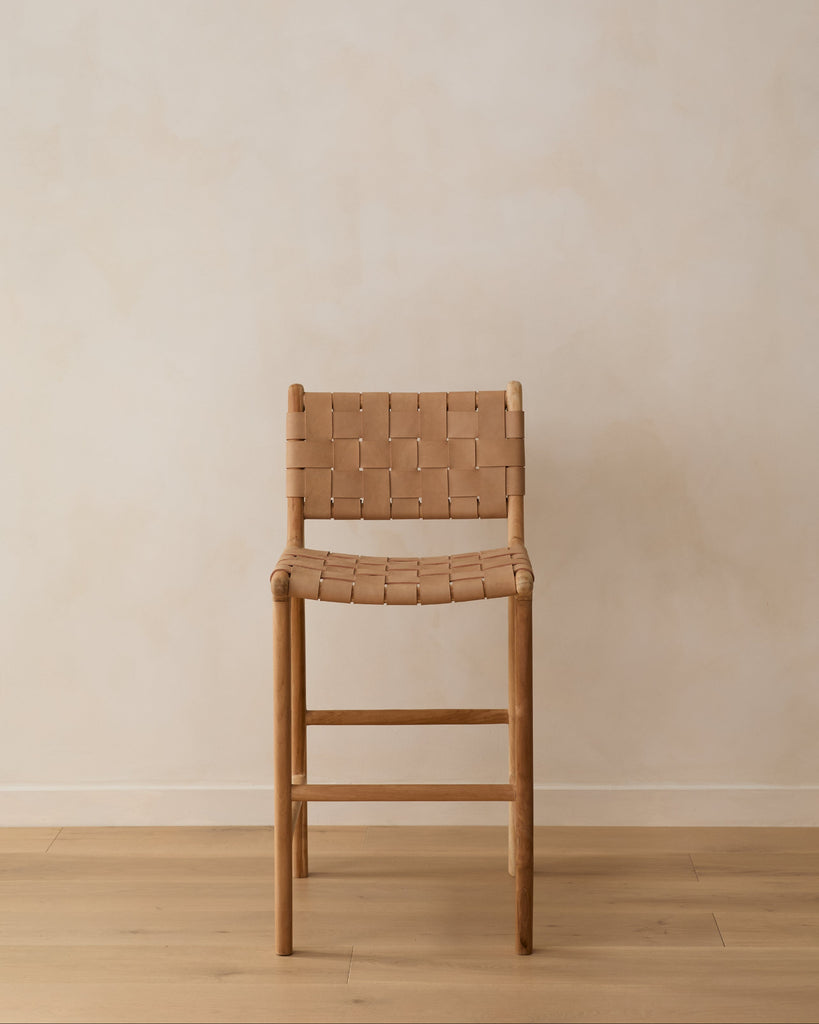 Front angle of Woven Leather Counter Stool in Beige on oak floors in front of beige wall