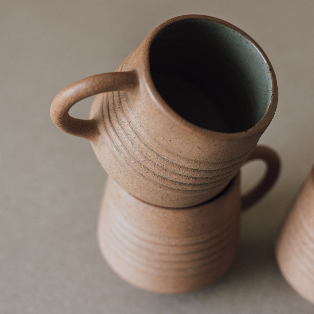 Handcrafted Anillo Mug ceramic cup with earth tone textures and glazed interior, holding 9.5 oz