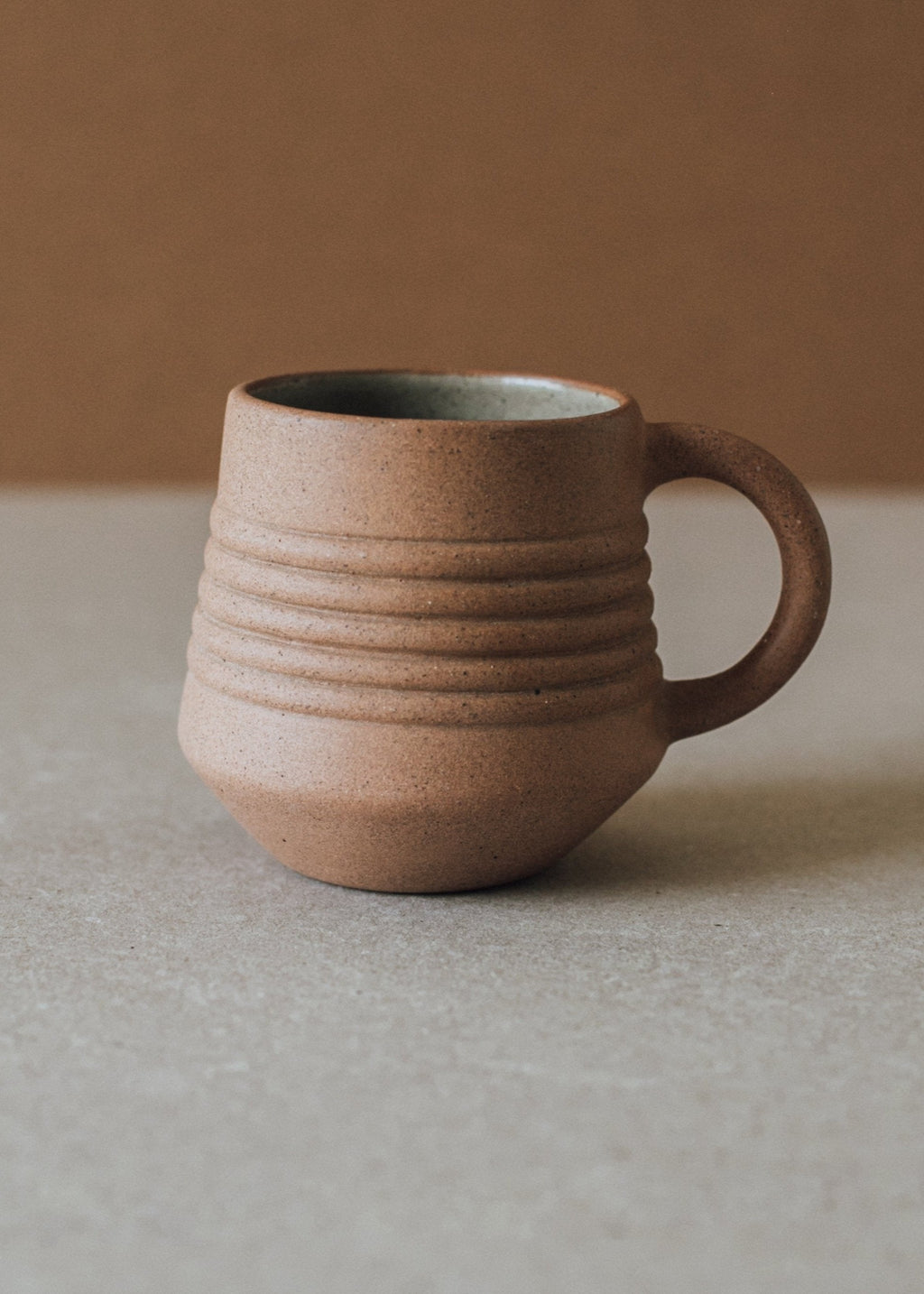Handcrafted Anillo Mug ceramic cup with earth-tone clay and glazed interior holding 9.5 oz