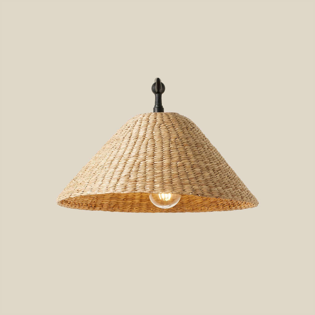 Bainbridge Oversized Swing Arm Sconce with a natural tan woven seagrass shade and dark metal fixture.