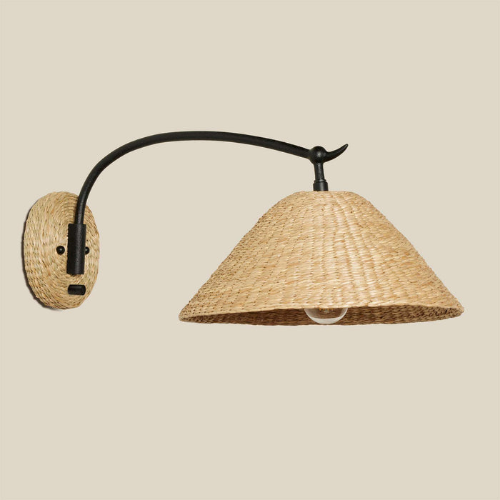 Bainbridge Oversized Swing Arm Sconce with a natural woven seagrass shade and wall plate, black curved metal arm