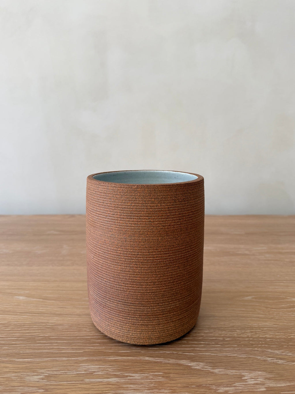 Capri Ceramic Utensil Jar in terracotta with ribbed texture on kitchen counter