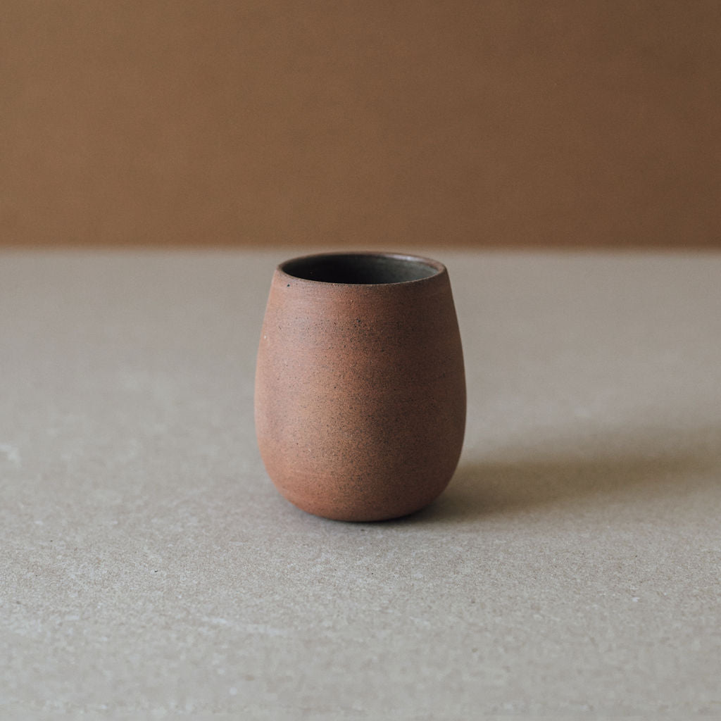 Handcrafted Bola Cup ceramic glass with earth tone textures and glazed interior
