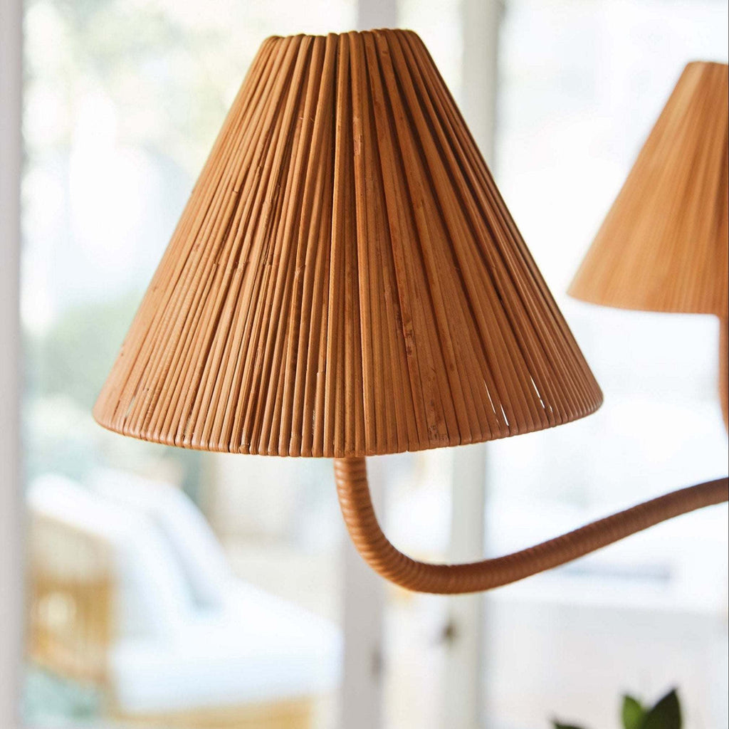 Delphine Chandelier with a warm brown rattan shade, tightly wrapped ribs, and a curved rattan-wrapped arm