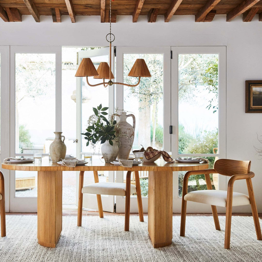 Delphine Chandelier in warm brown rattan with three woven shades, curved arms, and brass accents