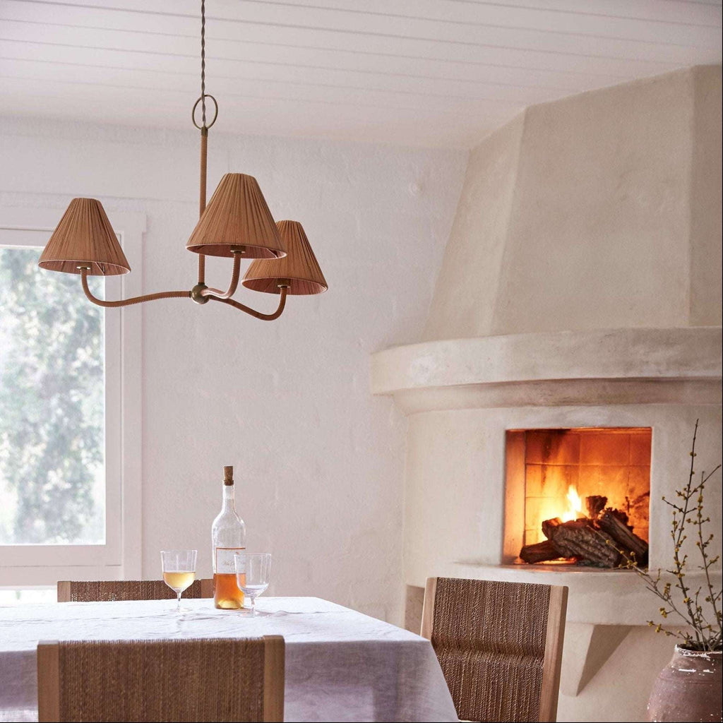 Delphine Chandelier with three brown woven rattan shades, curved arms, and a slender brass-toned frame