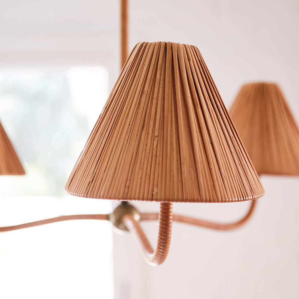 Delphine Chandelier with a warm natural rattan shade, tightly wrapped vertical ribs and brass-toned sculptural frame