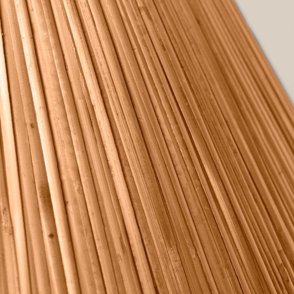 Delphine Table Lamp with a warm natural rattan shade, showing its tightly woven texture and slender ribbed strands.