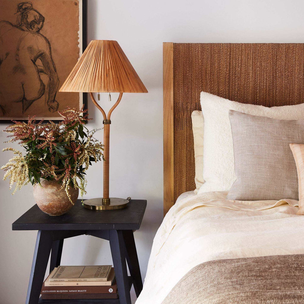 Delphine Table Lamp with a warm tan pleated shade, slender brass stem and branching arms, and round base