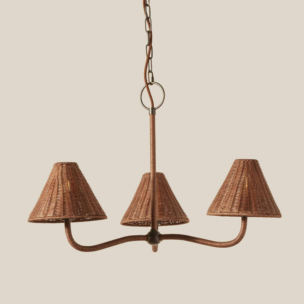 Delphine Wicker Chandelier with a brown woven wicker frame, three matching tapered shades and curved arms