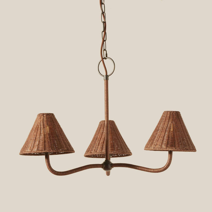 Delphine Wicker Chandelier with a brown woven wicker frame, three matching tapered shades and curved arms