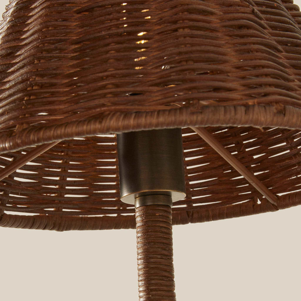Delphine Wicker Sconce with a warm brown woven wicker shade, visible wicker ribs and dark metal central fitting