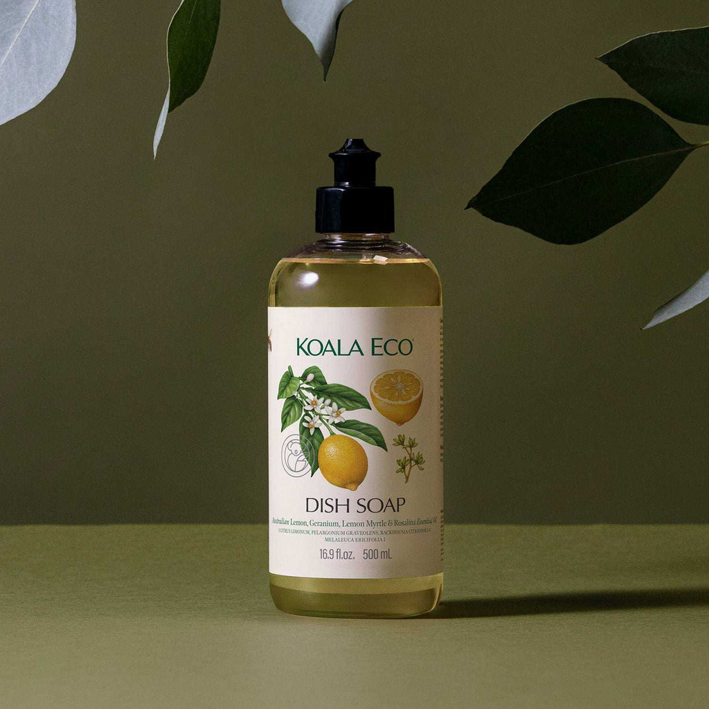 Dish Soap - Lemon, Geranium in a clear bottle with pale yellow liquid, a black pump, and citrus and botanical label art
