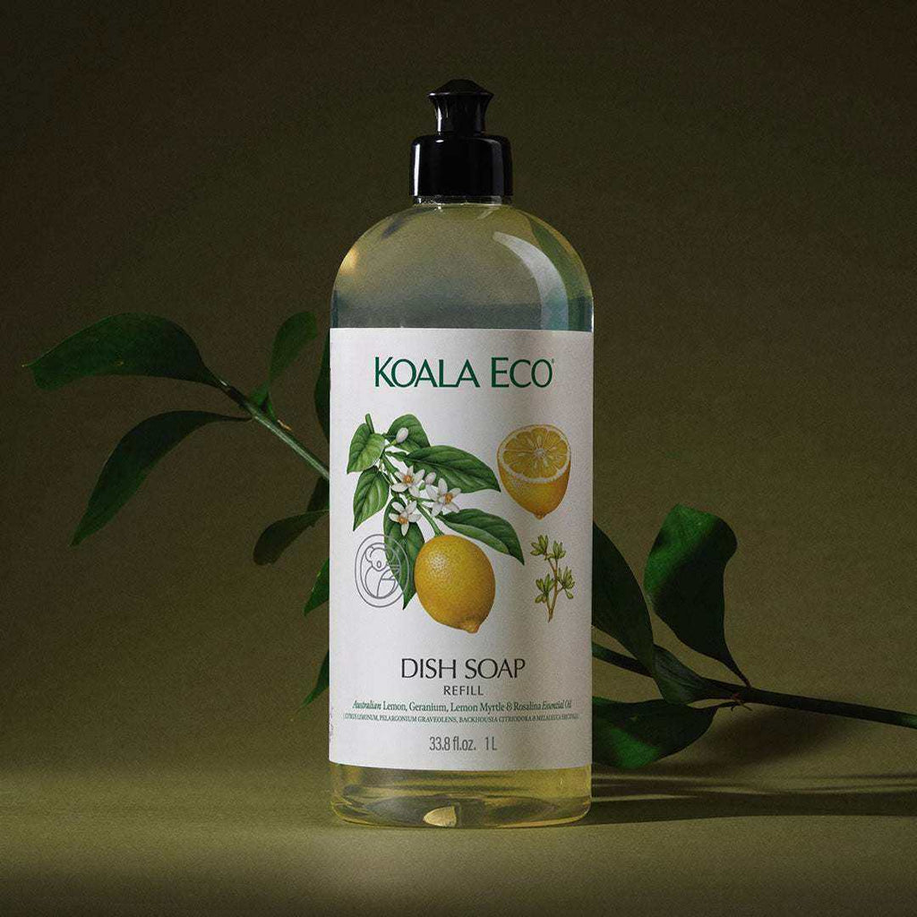 Dish Soap - Lemon, Geranium in a clear bottle with a black pump and white label featuring lemons and green botanicals