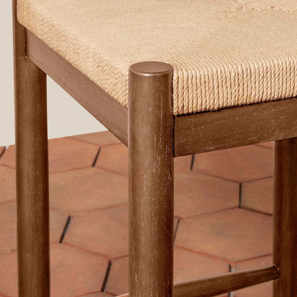 Estela Counter Stool with warm brown solid wood frame and natural woven rush seat, featuring rounded legs
