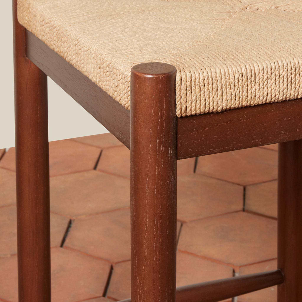 Estela Counter Stool with warm brown solid wood frame and natural woven rush seat featuring rounded legs