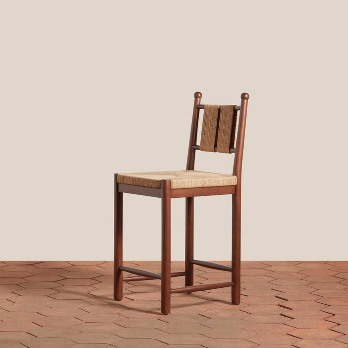Estela Counter Stool with warm brown solid wood frame, woven tan rush seat and slatted woven back