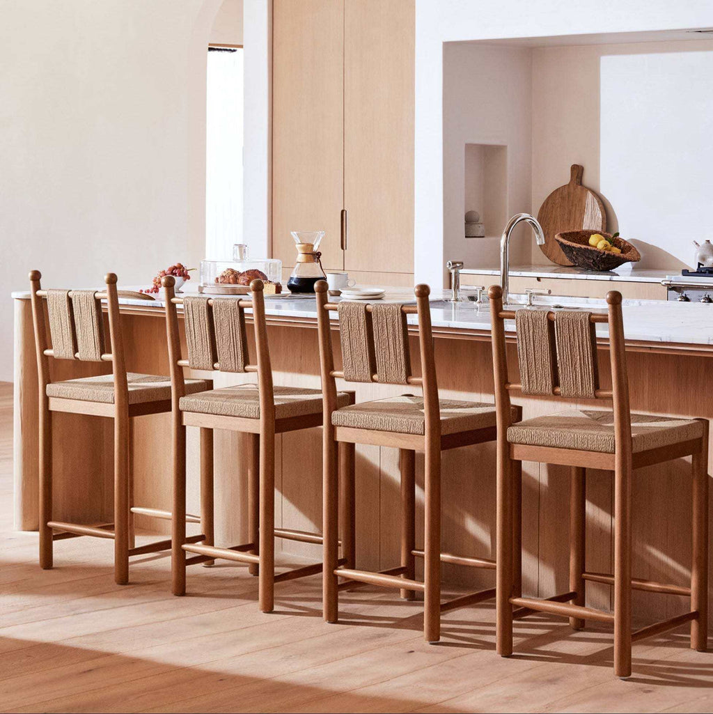 Estela Counter Stool in warm brown solid wood with hand-woven rush seat and woven cord back