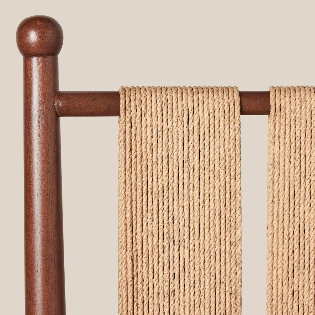 Estela Dining Chair with a warm brown solid wood frame and natural woven Danish cord back
