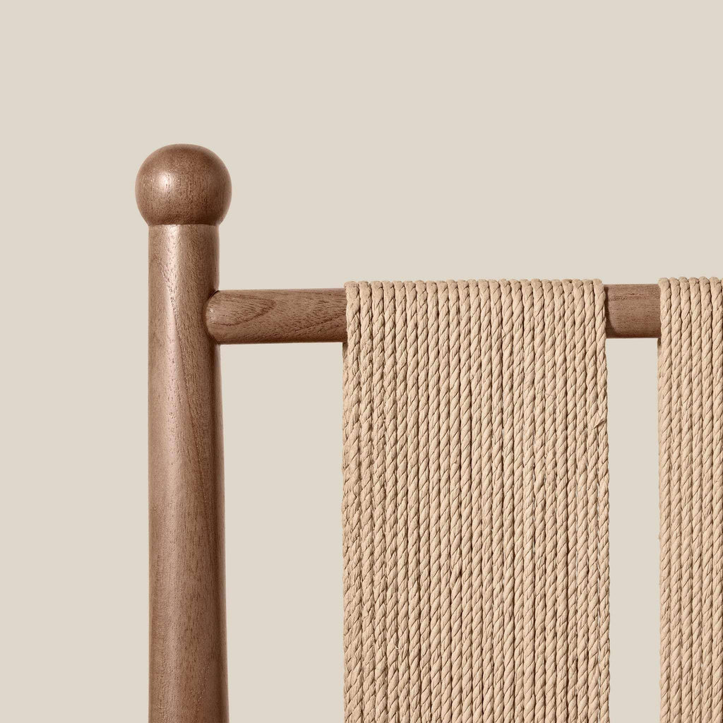 Estela Dining Chair detail showing a warm brown solid wood frame and tightly woven natural beige cord back