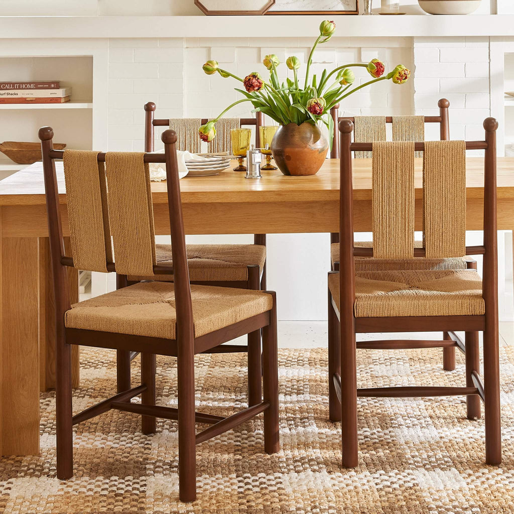 Estela Dining Chair in warm brown wood with woven tan rush seat and Danish cord back, ladder-back frame