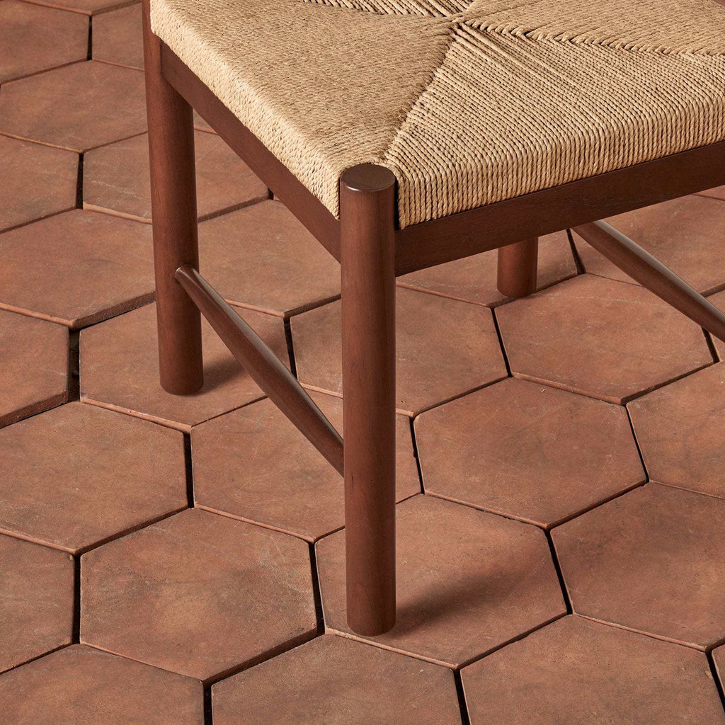 Estela Dining Chair with a dark brown solid wood frame and hand-woven natural rush seat with a geometric pattern
