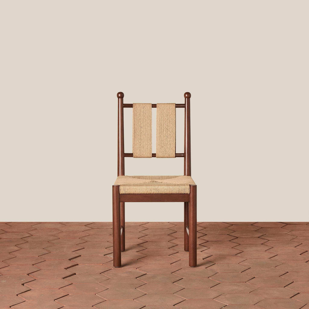Estela Dining Chair with a dark brown solid wood frame, woven natural rush seat and slatted cord back