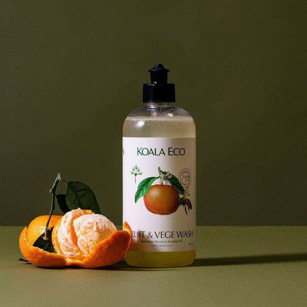 Fruit + Vegetable Wash in a clear bottle with a black pump and cream label featuring mandarin illustrations