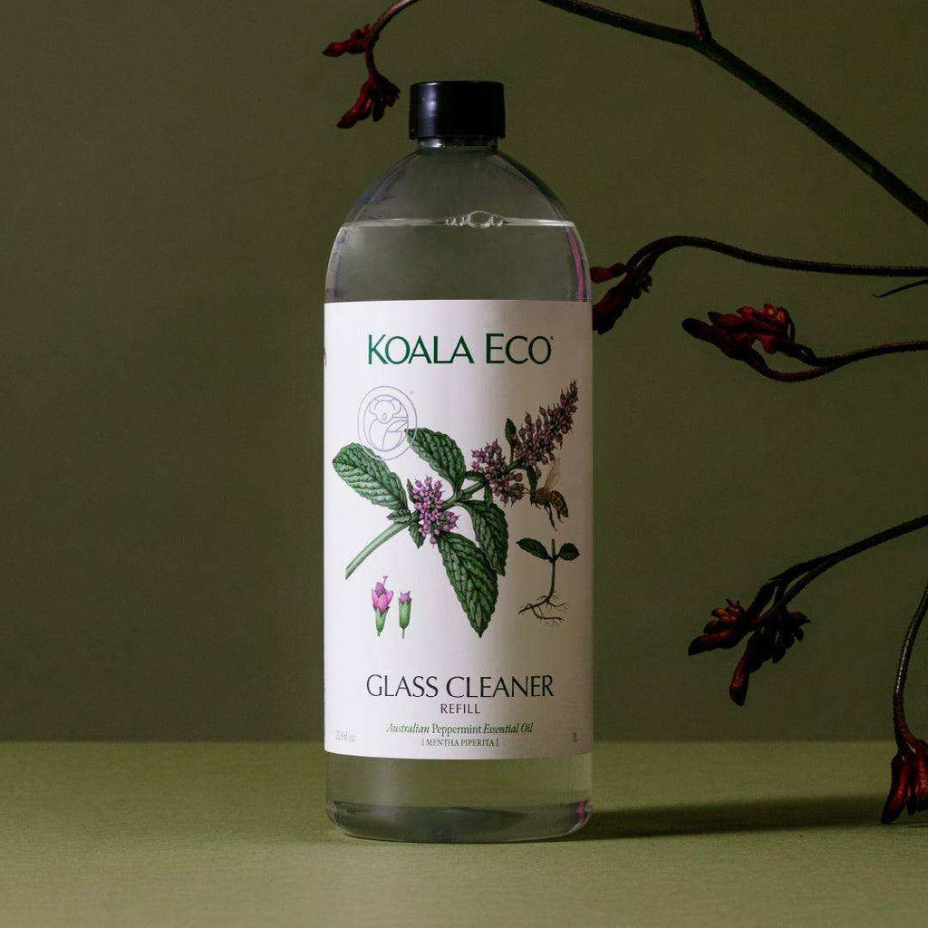 Glass Cleaner refill in a clear bottle with a black cap, botanical peppermint label and floral illustration