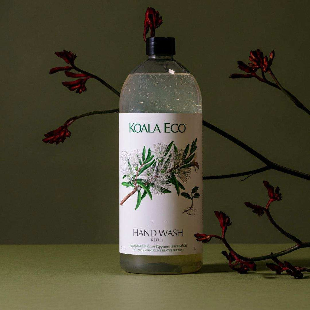 Hand Wash - Rosalina + Peppermint in a clear bottle with a black cap and white botanical label, showing a liquid refill.