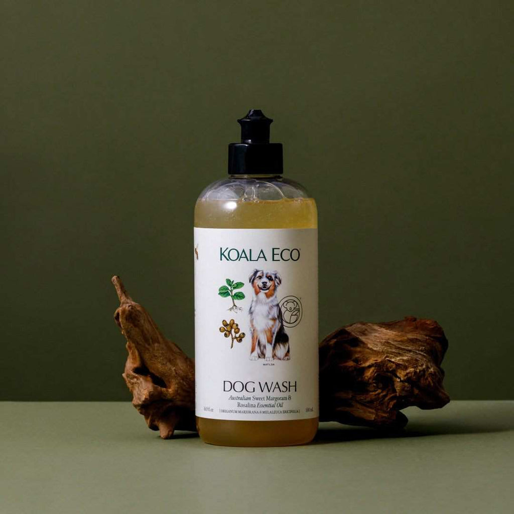 Koala Eco's Natural Dog Wash in a clear amber-filled bottle with a black pump and white botanical dog label