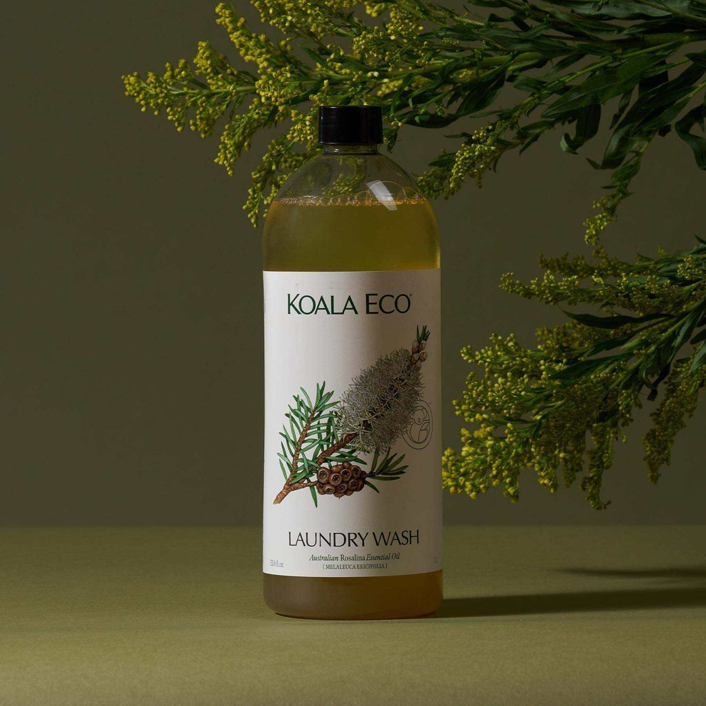 Laundry Wash - Lavender in a clear bottle with amber liquid, white botanical label and black cap, featuring green rosalina sprigs