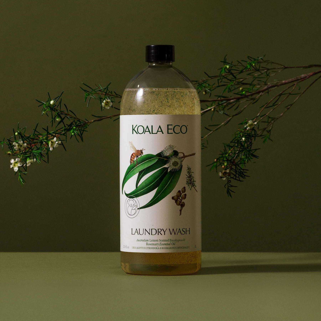 Laundry Wash - Lemon-Scented Eucalyptus in a clear bottle with a black cap, cream botanical label and golden liquid