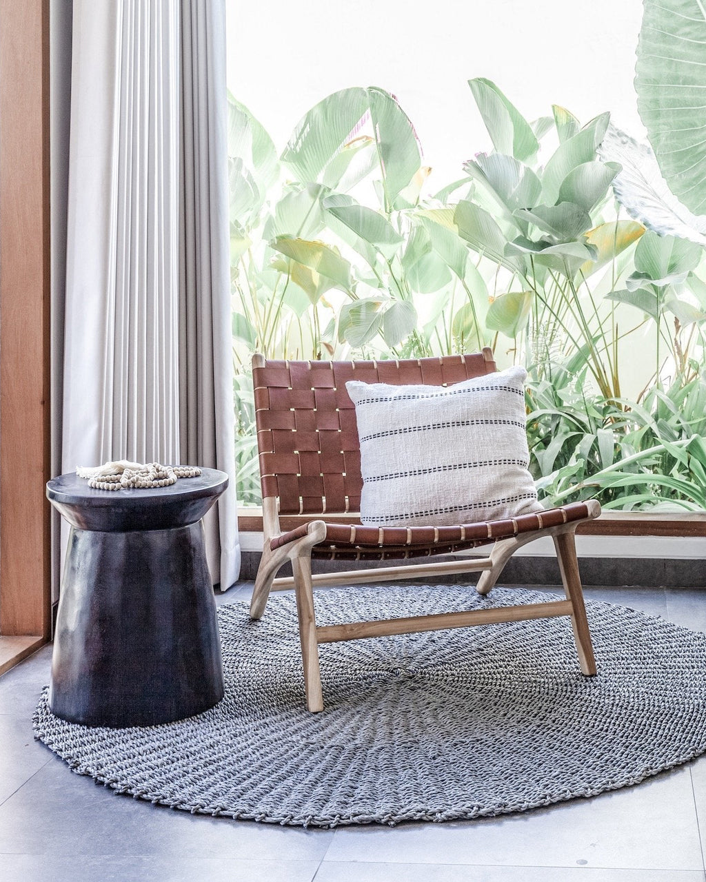 Woven leather lounge chair in saddle color with teak wood frame, handcrafted in Bali, second quality with natural leather and wood variations
