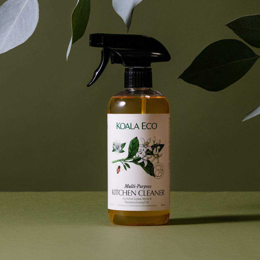 Multi-Purpose Kitchen Cleaner in an amber bottle with a black trigger and cream botanical label, lemon myrtle and mandarin scent