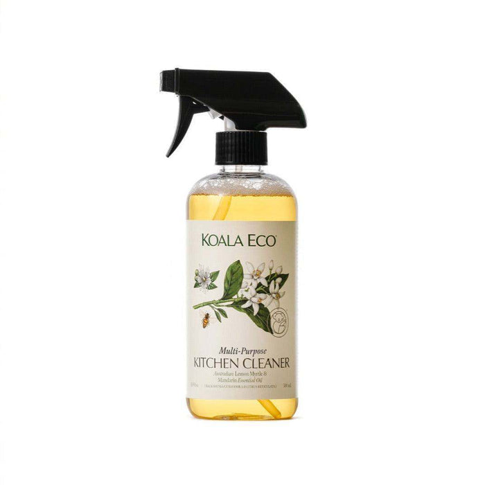 Multi-Purpose Kitchen Cleaner in a clear bottle with golden liquid, a black spray nozzle and a botanical label