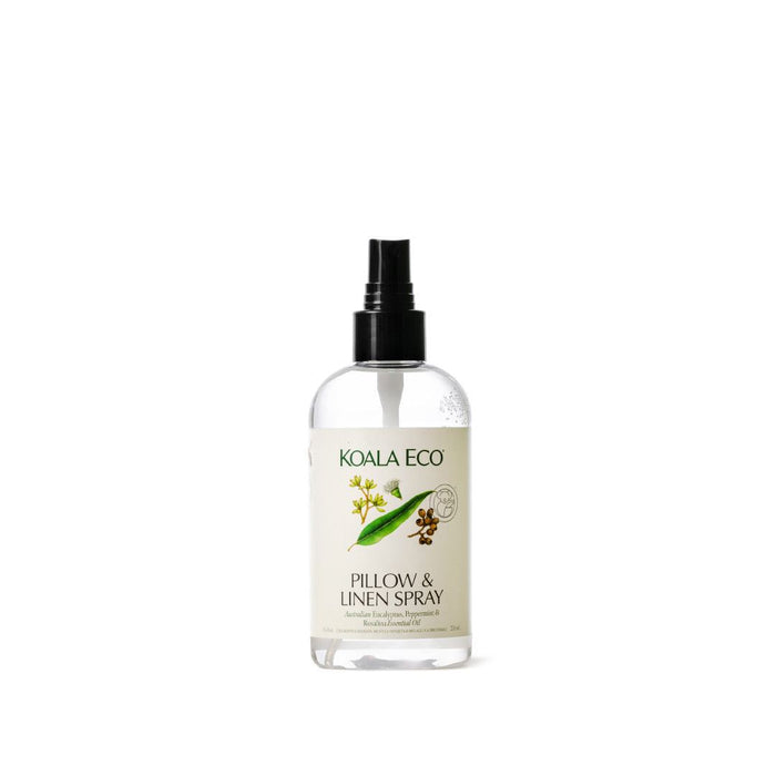 Pillow + Linen Spray in a clear bottle with a black pump, cream label, green branding and botanical illustrations
