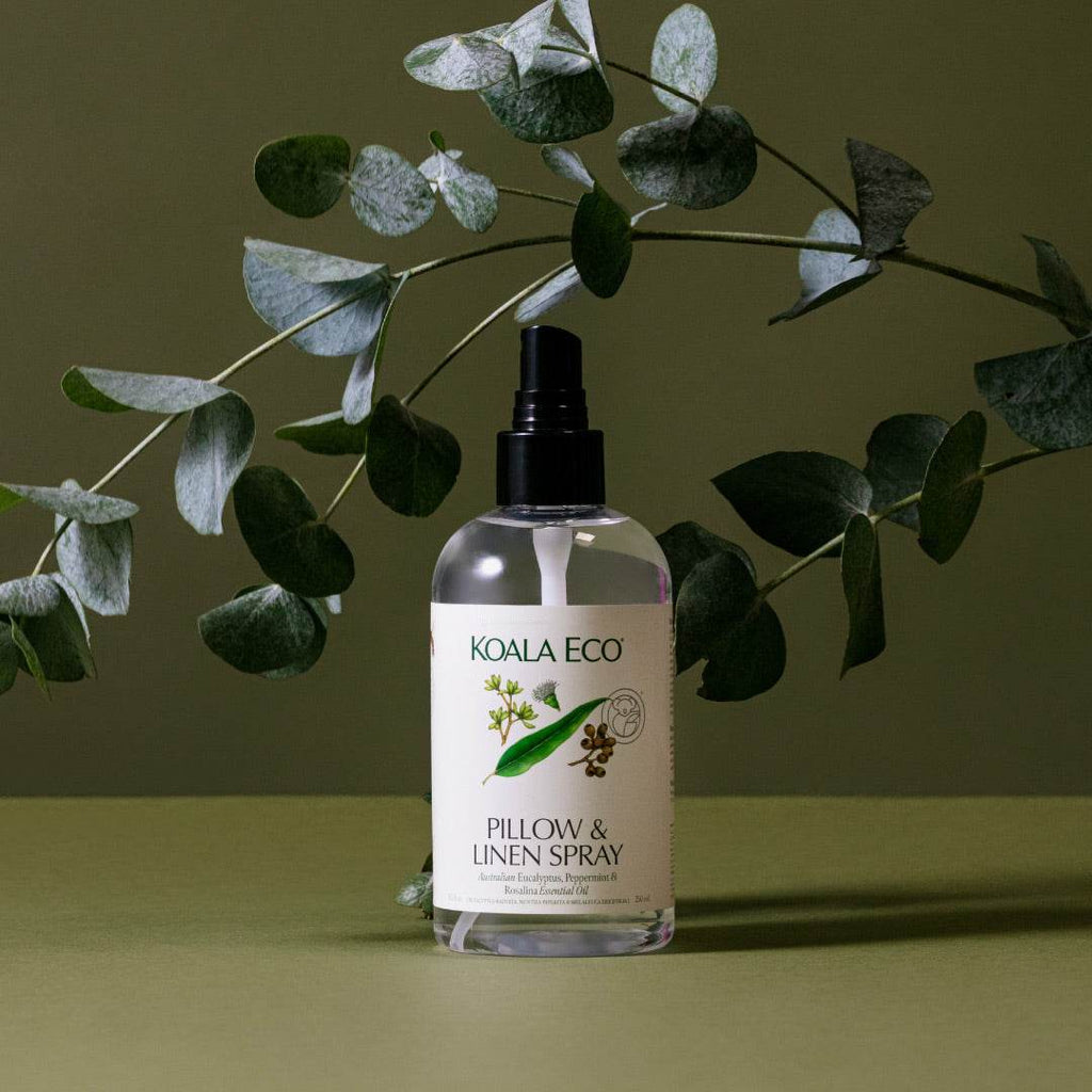 Pillow + Linen Spray in a clear bottle with a black pump, white label, and botanical eucalyptus, peppermint and rosalina artwork