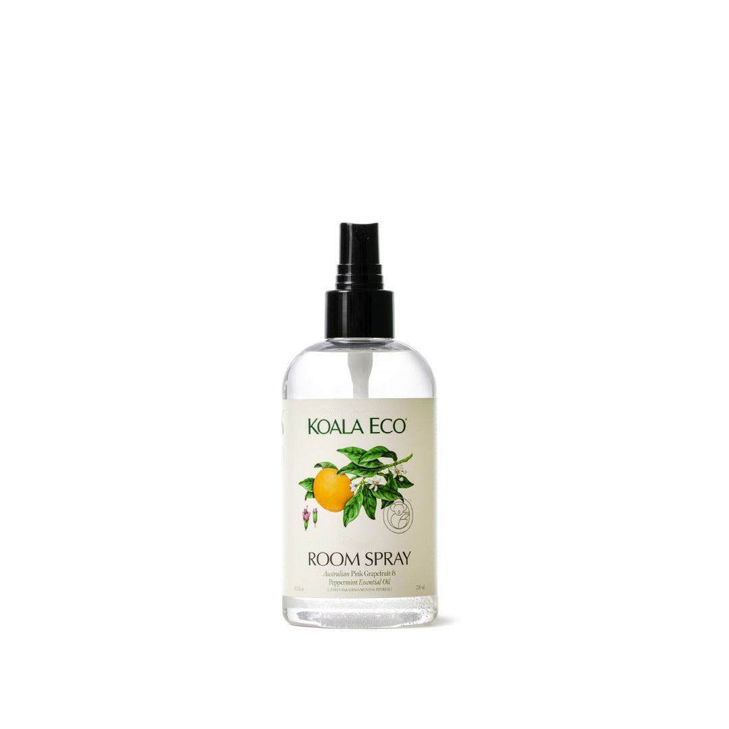 Pink Grapefruit + Peppermint Room Spray in a clear bottle with a black spray nozzle and botanical citrus label