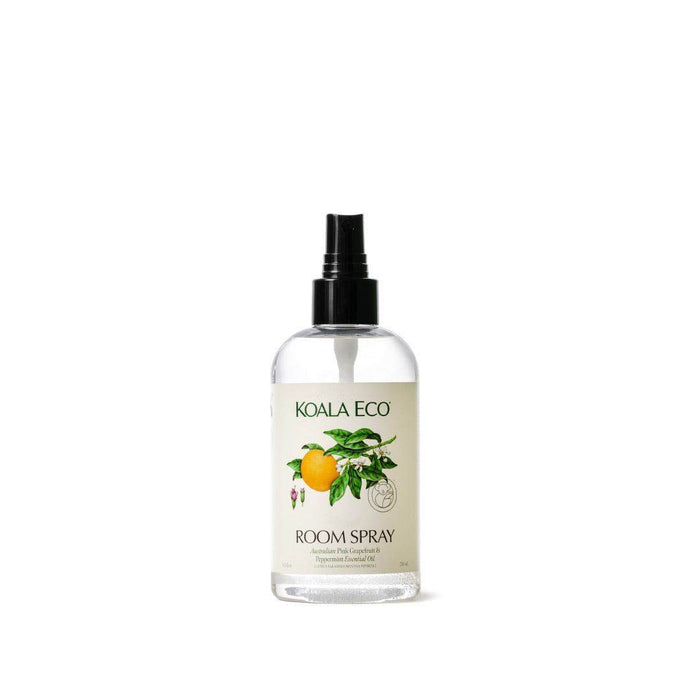 Pink Grapefruit + Peppermint Room Spray in a clear bottle with a black spray nozzle and botanical citrus label