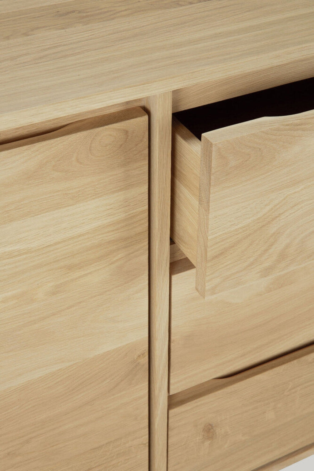Wave Sideboard in white oak with graceful contoured doors and handle-free design