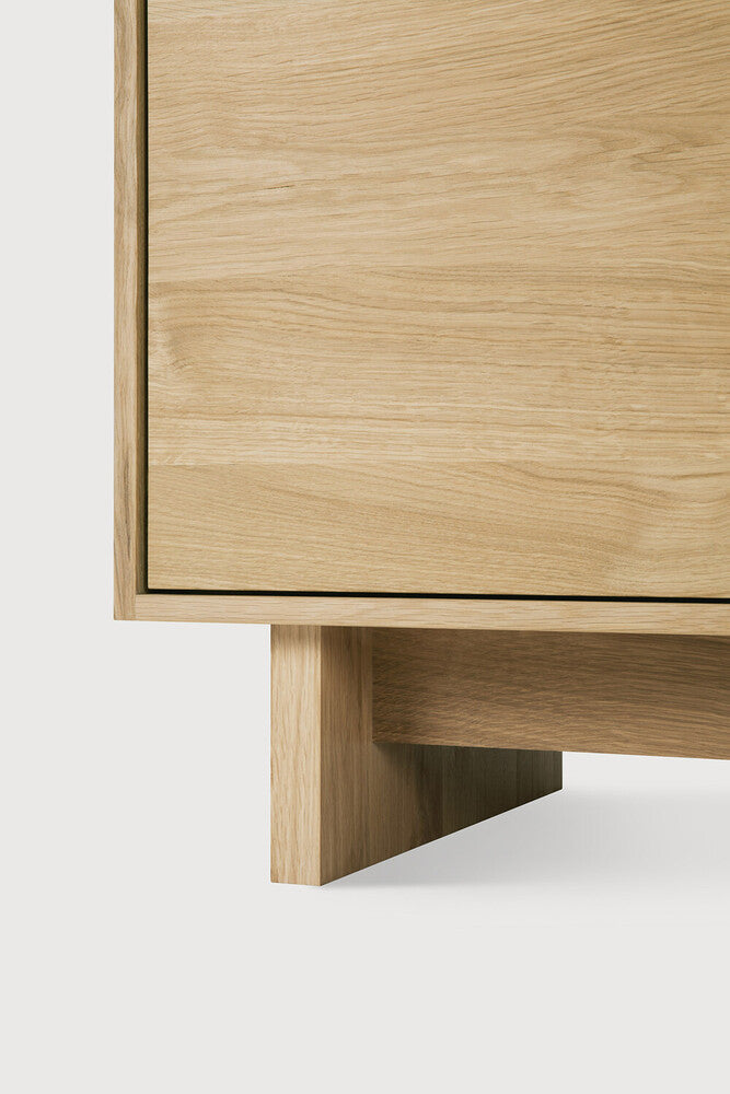 Wave Sideboard in white oak with graceful contoured doors and handle-free design