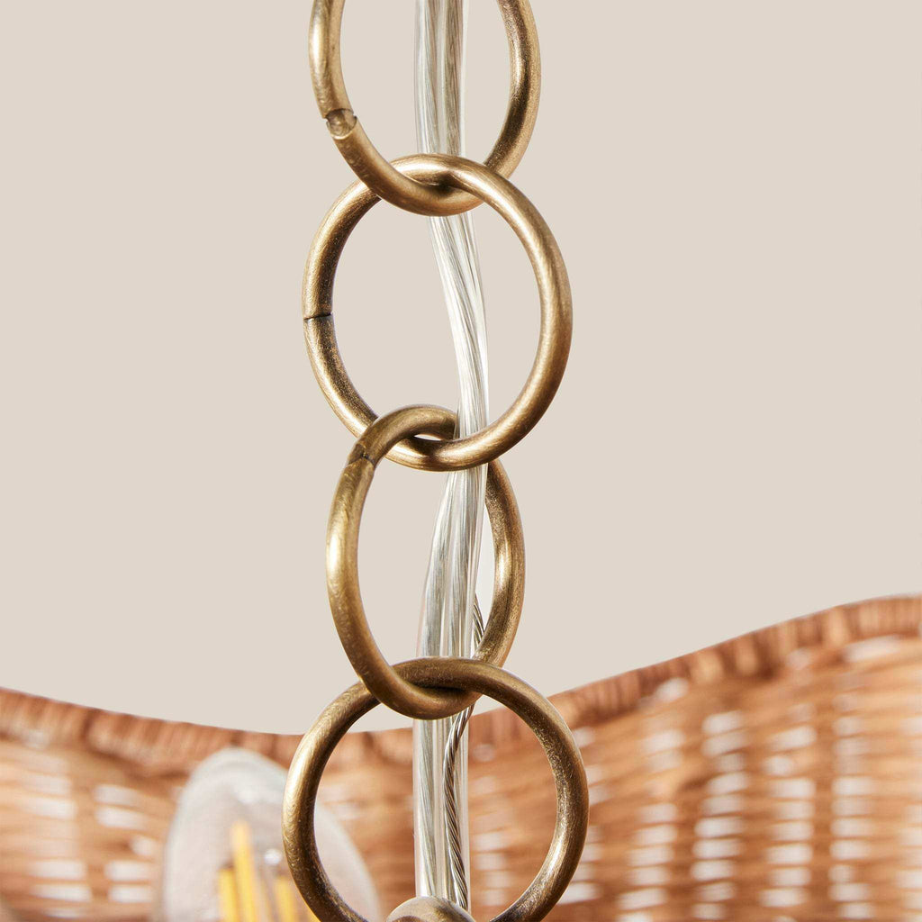 Ravello Flush Mount with a woven tan rattan scalloped shade and brass-tone chain links