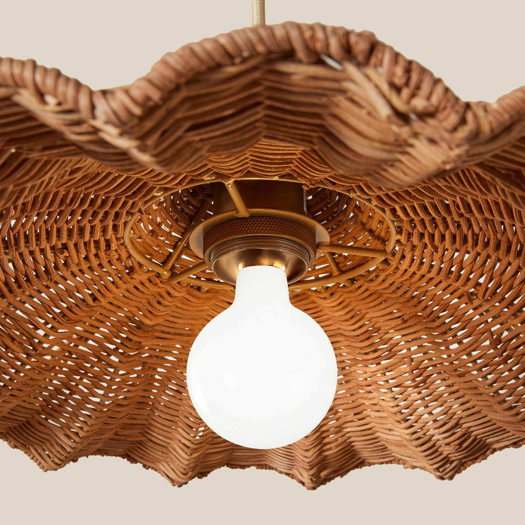Savannah Pendant with a warm brown handwoven wicker scalloped shade, brass-toned socket, and exposed white bulb