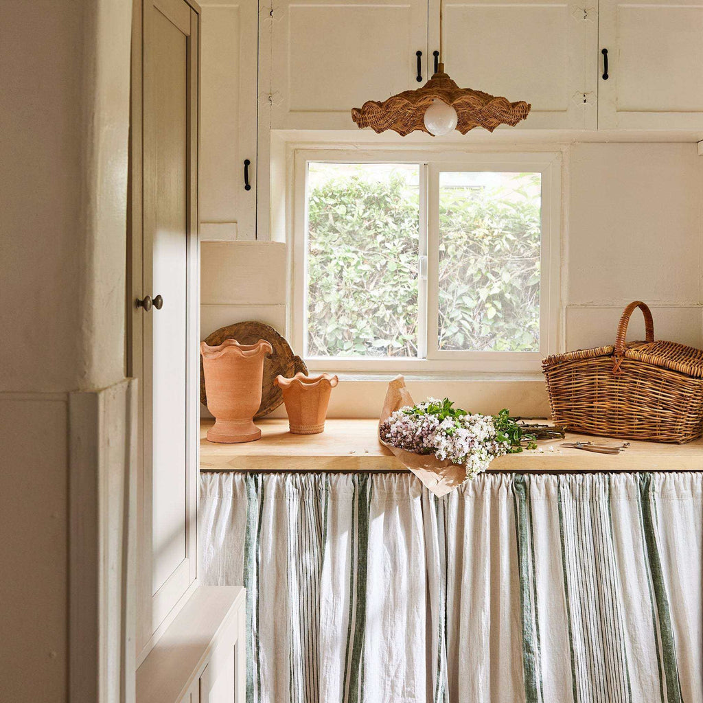 Savannah Pendant with a natural woven wicker scalloped shade and exposed central bulb, forming a low-profile fixture