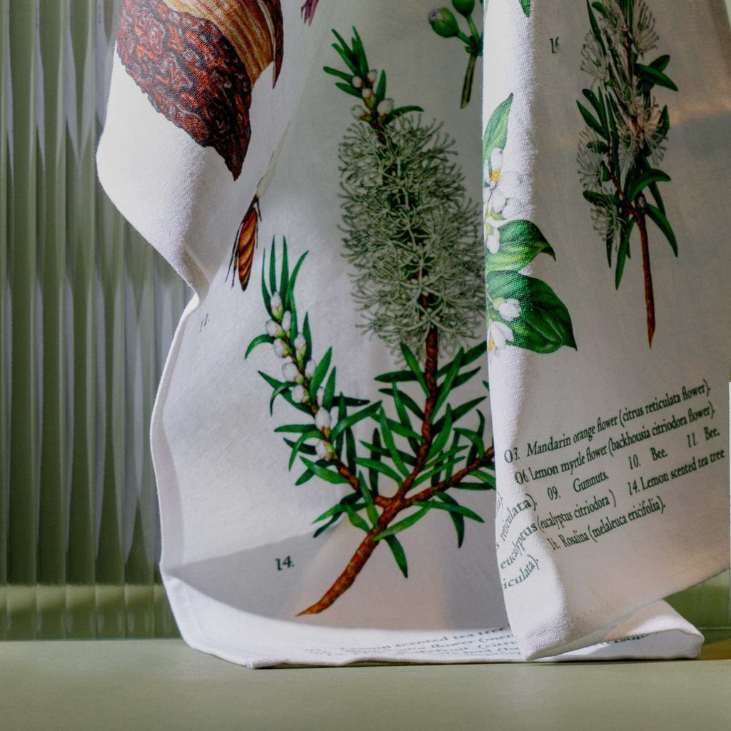 Terra Botanica Tea Towel in white linen-cotton with detailed green botanical illustrations and printed plant labels