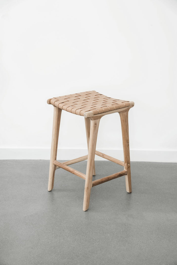 Comfortable, casual, leather-strapped counter height Backless Woven Leather Counter stool in Beige on a white background. Handmade in Bali using Teak wood and vegetable-tanned leather imported from Java. - Saffron and Poe