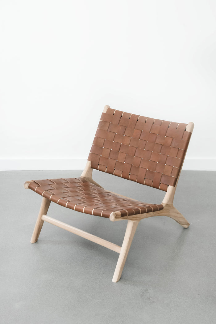 White background with our Woven Leather Strap Lounge Chair - Saddle. Handmade in Bali with Teak wood and vegetable-tanned leather imported from Java. - Saffron and Poe