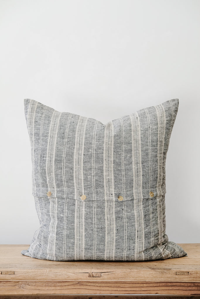 Back view of No. 48 - Striped Linen Pillow on an Antique Bench against a white wall. - Saffron and Poe